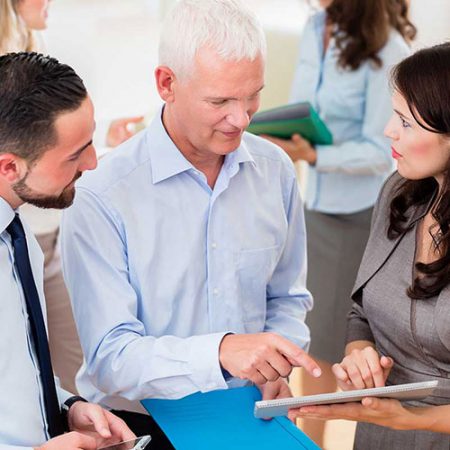 Professional outsourced company financial director talking to colleagues