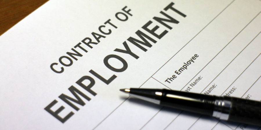 employment rights bill image shows white paper contract of employment with pen on desk