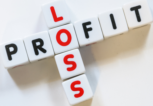 A conceptual photograph representing the financial services offered by RiverView Portfolio, Property Tax Advice, Expat Tax Advice, and Crypto Tax Advice. The image features white cubic tiles spelling 'PROFIT' horizontally in black lettering and 'LOSS' vertically in red lettering, with the two words intersecting at the letter 'O' against a clean white background.