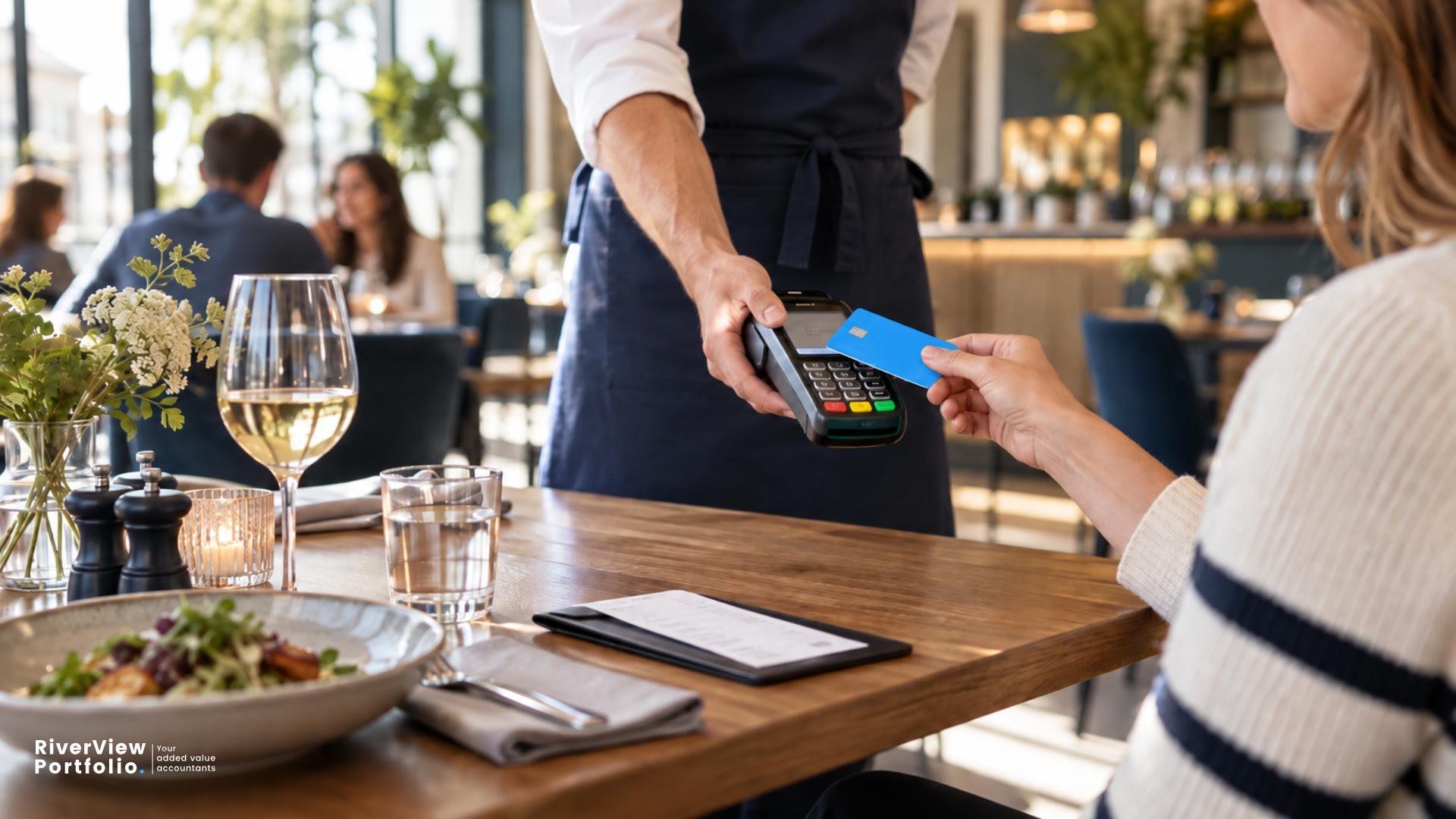 Customer paying by debit card at a restaurant, illustrating how tronc schemes work and the rules for distributing tips.